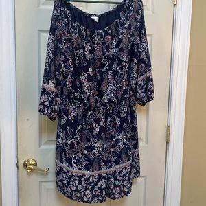 Navy floral romper with elastic neck line can be worn off the shoulder